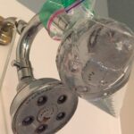 cropped-shower-head-wrapped-in-vinegar-bag-diy-shower-cleaner-hard-water-1.jpg